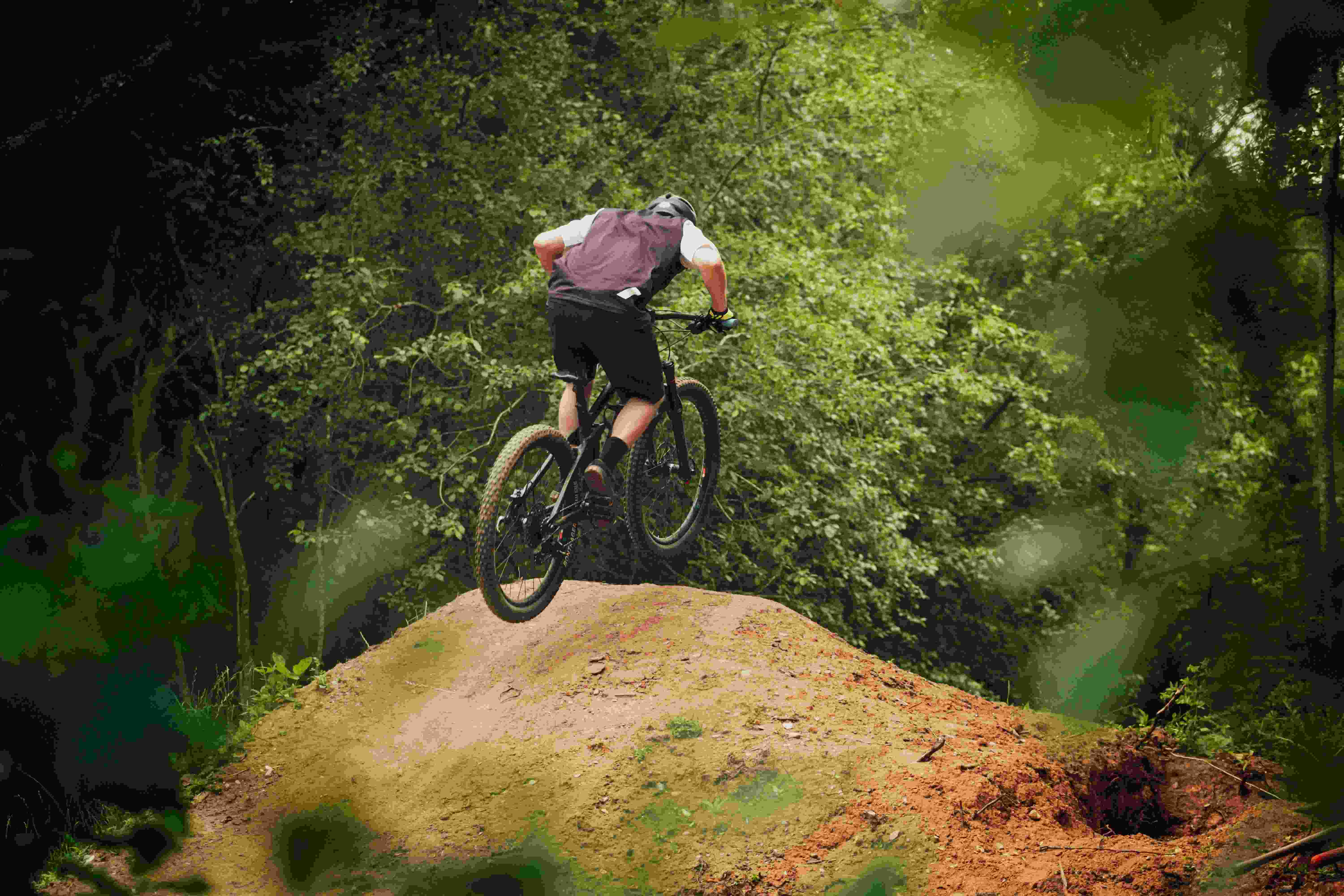 Biker riding off ramp